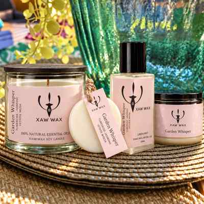The Full House in Garden Whisper: soy candle, scented sachet, Linen Mist and small candle on a woven mat