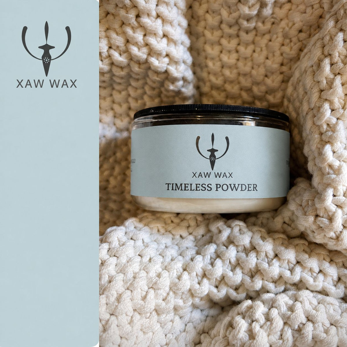 Timeless Powder 100 g candle in a cream blanket with a coordinated blue-gray label and full XAW strip
